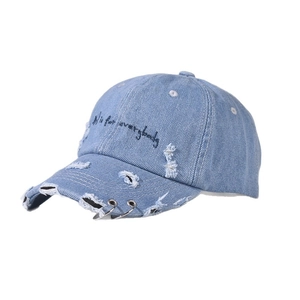 Distressed light blue denim baseball cap with iron rings and embroidery on white background