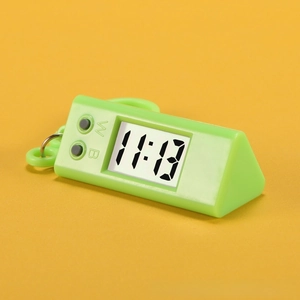 Detail of green triangle digital watch with LCD screen and carabiner clip for students