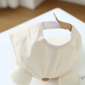 Off-white kids baseball cap with bear ears and adjustable strap seen from back view