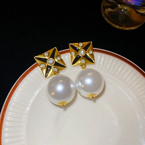 Detailed close-up of vintage square black pearl earrings with sparkling crystal accents