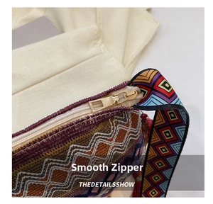 Detailed close-up of woven bohemian texture and gold metal zipper on a crossbody bag