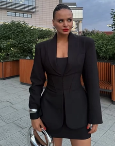 Outdoor shot of a chic black slim-fit blazer suit with a matching mini skirt for women