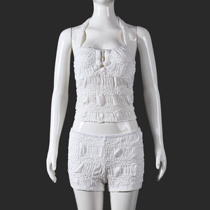 Detail of white popcorn fabric texture on halter crop top and shorts set for women