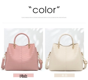 Detail of pink and beige embossed crocodile pattern handbags with top handles and straps