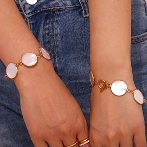 Close-up of 18K gold plated OT clasp bracelet with natural white mother-of-pearl charms