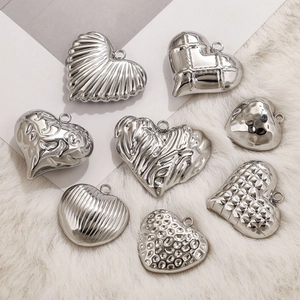 Eight unique textured silver stainless steel heart pendants on white fur background