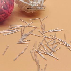 Detailed view of bulk S925 sterling silver earring pins on an orange background