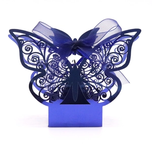 Close-up of blue laser-cut butterfly gift box with elegant satin ribbon bow