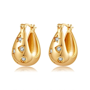 Close-up of gold-plated hoop earrings with sparkling zircon stars and droplet design