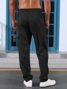 Rear view of black cargo pants showing the lightweight fabric and loose straight-leg cut