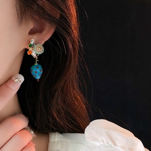 Blue strawberry bead earrings with pearls and rhinestones worn by an Asian model