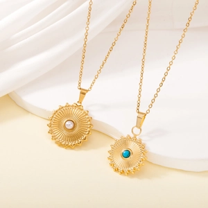 Detailed shot of gold sun necklaces with white pearl and turquoise inlay accents