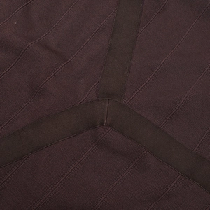 Macro detail of dark brown ribbed knit fabric showing high-quality stitching and texture