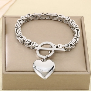 Detail of silver stainless steel heart pendant bracelet with T-bar toggle on a gift box