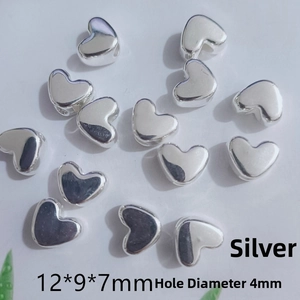 Detail view of 12mm silver heart spacer beads with 4mm large holes for jewelry making