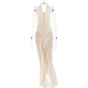 Detail of white halter neck dress featuring pleated texture and layered ruffle slit hemline