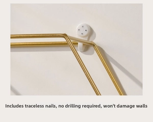 Detail of gold metal wire wall shelf featuring white non-marking nail for easy installation