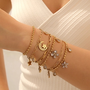 Layered gold-plated stainless steel bracelet with star, moon and butterfly charms