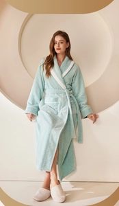 Detail of mint green waffle robe featuring plush white trim and matching waist tie belt