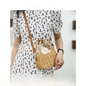 Detail of hand-woven straw crossbody bag with leather strap and drawstring liner
