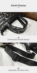 Detail of black quilted puffer bag showing plush handle and adjustable shoulder strap