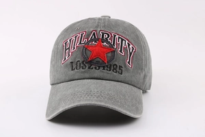 Detail of grey washed cotton baseball cap featuring red star and vintage embroidery