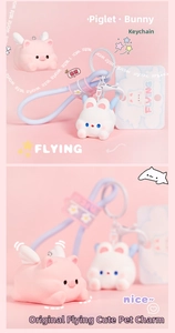 Close-up of flying pig and rabbit keychains with purple straps and cute wings decor