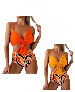 Detail of two-piece bikini with bow knot top and wave print high-waisted bottoms