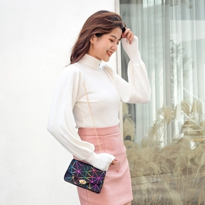 Fashionable black geometric laser chain crossbody bag worn with casual outfit