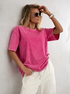 Detail of pink acid wash cotton T-shirt showing vintage texture and shoulder drop