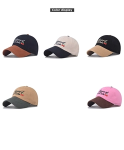 Detail view of five color combinations of washed cotton baseball caps with cherry embroidery