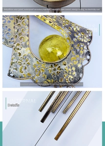 Solar moon wind chime with cracked glass ball and bronze metal hollow pattern detail