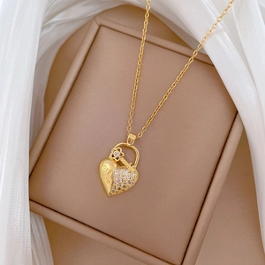 Macro shot of gold heart locket and key necklace with diamonds and LOVE YOU engraving