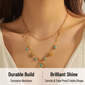 Close-up of double-layered gold necklace featuring turquoise beads and star sun pendants
