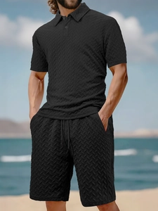 Close-up of black men's short sleeve polo and shorts set with textured herringbone weave