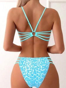 Detail of blue bikini back with multi-strap metal ring and leopard print bottom