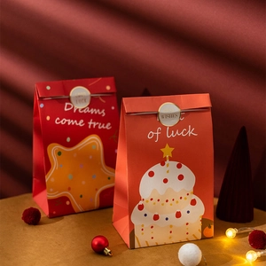 Christmas paper gift bags with Dreams Come True prints and gold seal stickers
