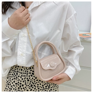 Detailed close-up of a mini light pink jelly handbag featuring a metallic gold chain strap