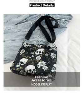 Detail of black nylon crossbody bag featuring white skull and floral prints with strap
