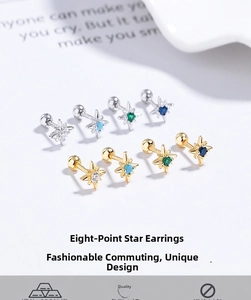 Detail of 925 sterling silver star stud earrings with colorful zircon stones in gold and silver