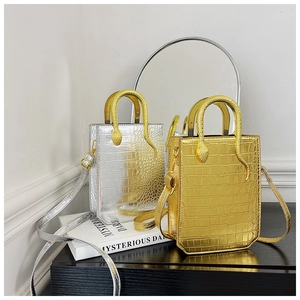 Detail of mini crocodile pattern bags with gold and silver snakeskin handles
