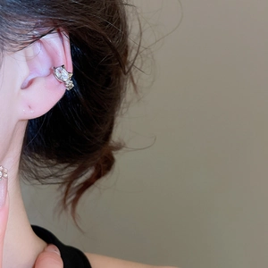 Detailed view of silver cat ear cuff with zircon crystals on a female model