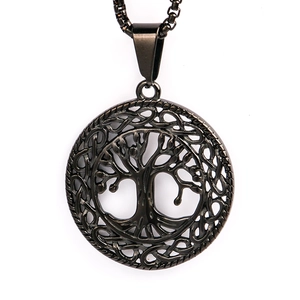 Macro shot of stainless steel Tree of Life pendant with intricate hollow design on white base