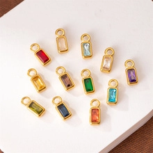 Flat lay of rectangular colorful gemstone pendants for monthly necklaces in gold frames