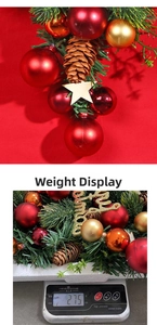Detail of Christmas wreath with red ornaments pine cones and weight measurement 275g