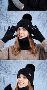 Close-up of winter knit set featuring a beanie with fur pom and leather logo detail