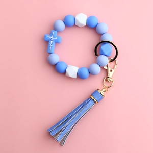 Detail of blue silicone beads, Jesus cross pendant and leather tassel on key ring