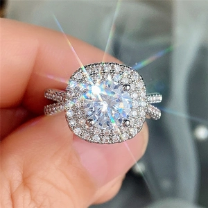 Detailed macro of a silver halo engagement ring with double diamond borders and split shank