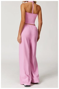 Pink backless yoga set featuring halter neck top and wide-leg sports trousers for fitness