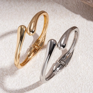 Minimalist irregular metal open bracelets in gold and silver finish with teardrop design
